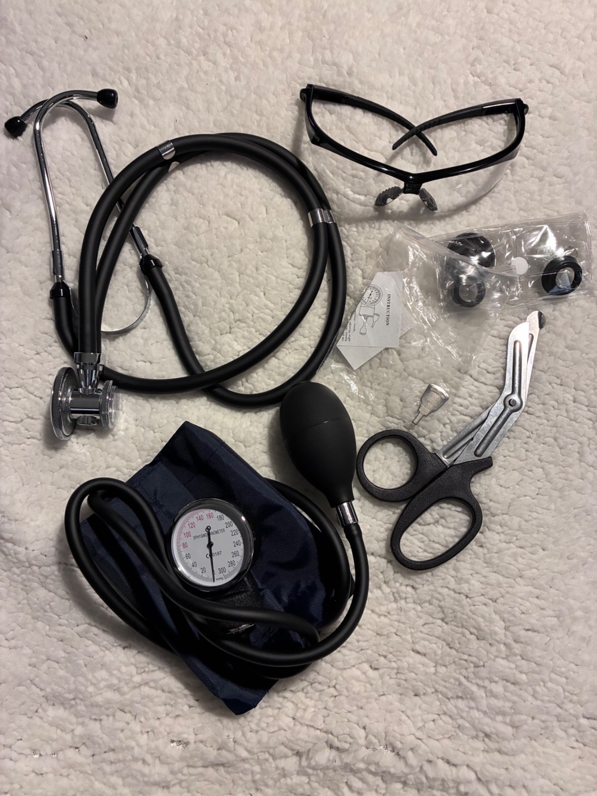 medical kit, stethoscope, blood pressure, tape scissors, etc.